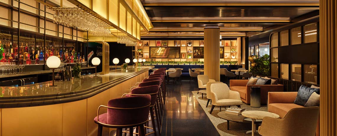 Sapphire Lounge at Philadelphia International Airport with a long bar counter, high chairs, elegant lighting, and plush seating areas.